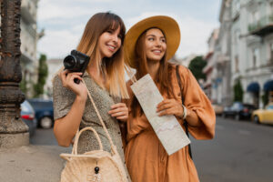stylish young women traveling together summer fashion style dresses